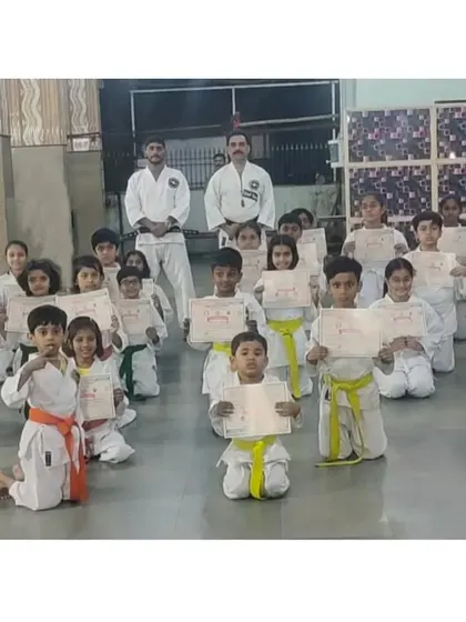 Students from our Seawoods branch proudly display their certificates after their belt achievement exam.