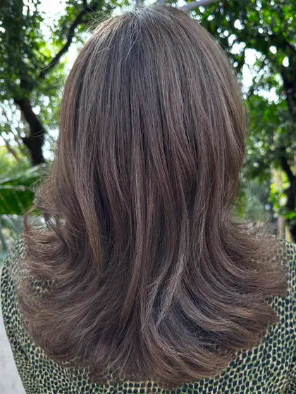 The back view of her sleek, ash-toned holiday hair.