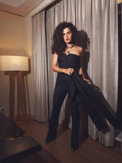 The complete look. This full-length shot shows the flattering silhouette of the high-waisted trousers and strapless top, a perfect modern power suit alternative.
