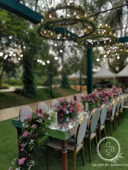 The floral runner on the mirrored table was designed to look like it was cascading off the edge. The combination of lush flowers and twinkling lights made for a serene dining experience.