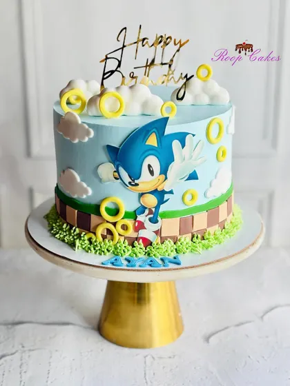 A super-sonic celebration for a special birthday. This cake brings the world of Sonic the Hedgehog to life with golden rings, fluffy clouds, and the speedy hero himself.