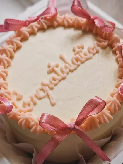 A lovely "Congratulations" bento cake with delicate pink ribbons. These mini cakes are my go-to for celebrating all of life's little wins.