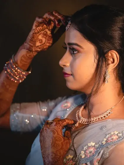 A profile shot of Shilpa's reception look. The soft makeup and simple hairstyle allowed her natural beauty and the delicate details of her saree to shine through.