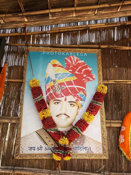 A portrait of Om Banna himself, adorned with a garland, at the temple dedicated to him.