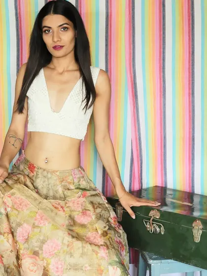 This is a custom-designed Chikankari crop top with a plunging V-neckline. The delicate hand embroidery makes it a timeless piece that you can pair with countless skirts, palazzos, or even a saree.