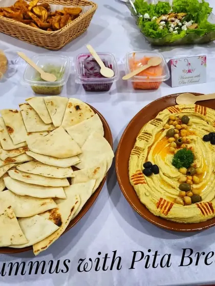 A beautiful platter of hummus and pita bread, a classic Mediterranean starter perfect for any gathering.