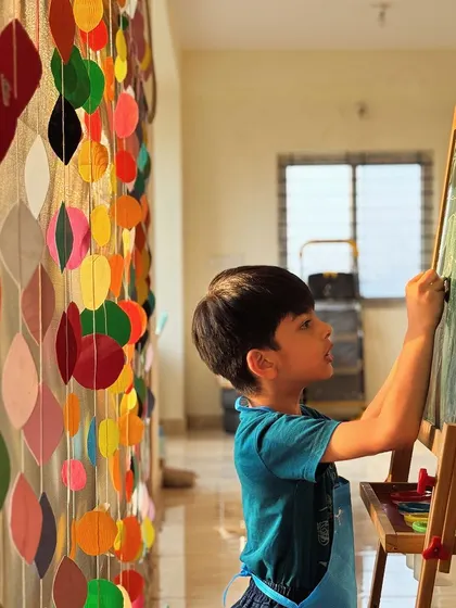 A young artist at the chalkboard. Sometimes the creativity spills over from the main activity, and I love to encourage it.