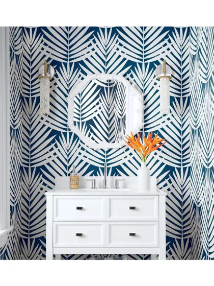 Exotic and super dramatic, the 'Croatia' palm leaf wallpaper in blue and white makes a powerful statement. It turns this powder room into a vibrant, tropical-inspired escape.