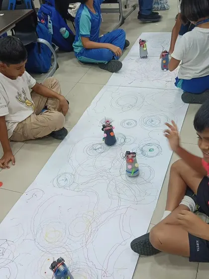 There's nothing like the excitement of seeing your own creation in action. These students are having a blast racing the scribbling bots they built and decorated themselves.