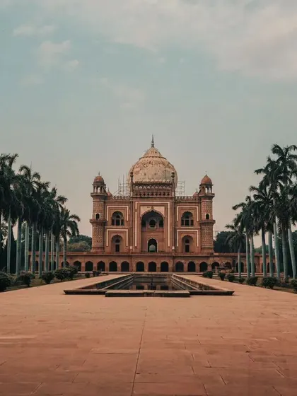 The beautiful symmetry of Safdarjung Tomb in Delhi, lined with palm trees. It's a testament to the city's grand and glorious past.