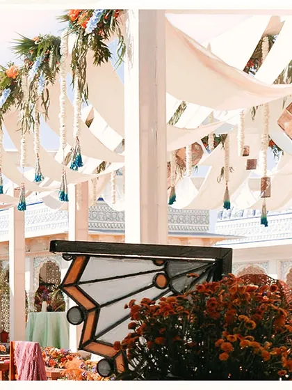 A close-up of the ceiling decor, featuring flowing drapes and hanging tassels. This adds texture and movement to the space, creating a dynamic and festive atmosphere.