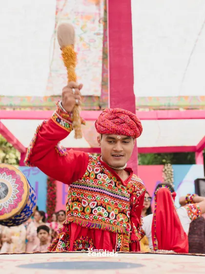 A dhol player in his element, bringing the energy to the celebration. We capture all the elements that contribute to the wedding's vibrant atmosphere.