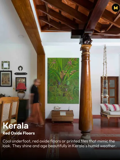 In Kerala, red oxide floors are a staple for a reason. They stay cool underfoot, age beautifully in the humid weather, and provide a rich, earthy foundation for the entire home, as seen in this space with its traditional wooden pillar and swing.