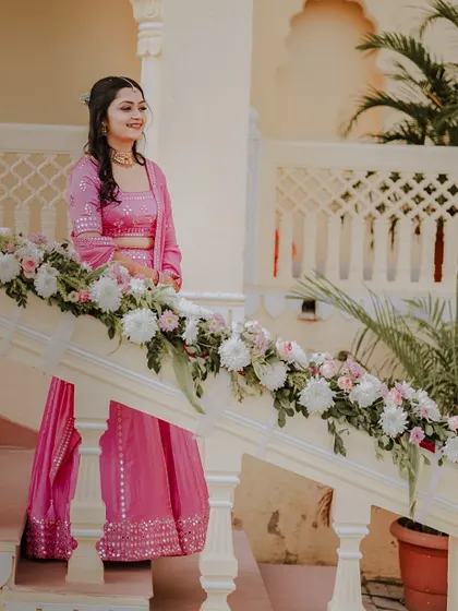 A serene portrait of the bride, Anjali, at her Mehendi. I captured her standing by a beautifully decorated staircase, her smile as bright as the floral arrangements.