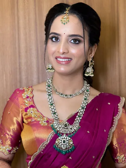 Chandana's engagement look. She opted for a glamorous look with a smokey eye and a neutral lip, paired with stunning diamond and emerald jewelry.