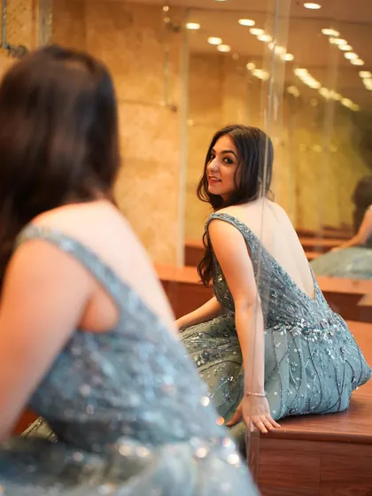 A reflection shot in the grey gown, playing with angles and showing off the outfit from a different perspective.