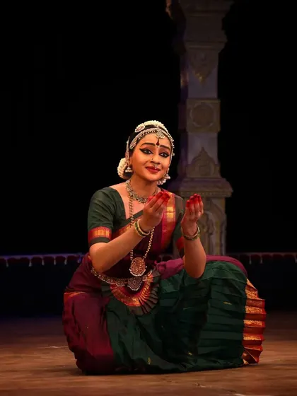Offering flowers to the deity, a gesture of devotion and respect. This moment of abhinaya is a beautiful blend of storytelling and worship.