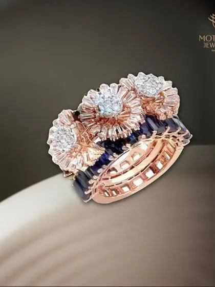 A stunning triple-band ring featuring floral diamond clusters set against deep blue sapphires. The combination of rose gold and white diamonds adds another layer of richness to the design.