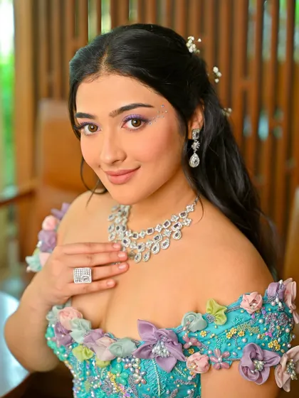 Another portrait from this creative shoot. The half-up hairstyle is adorned with delicate, baby's breath-like accessories, adding to the fairytale vibe.