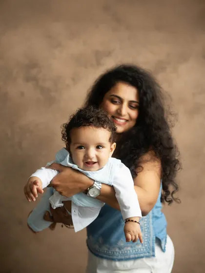 The pure joy of a mother holding her baby. I aim to capture these candid, happy expressions that show the genuine bond you share.