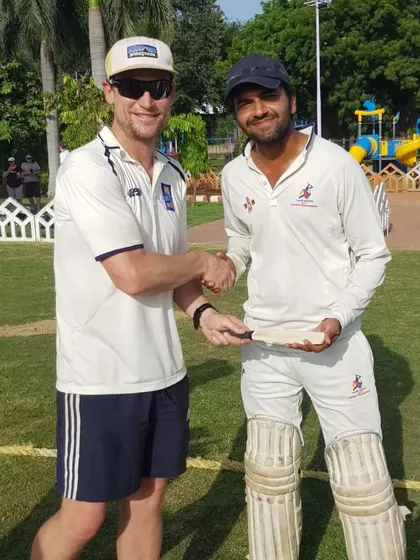 A senior player from my academy shares a moment with a New Zealand cricketer, a great learning experience for him.