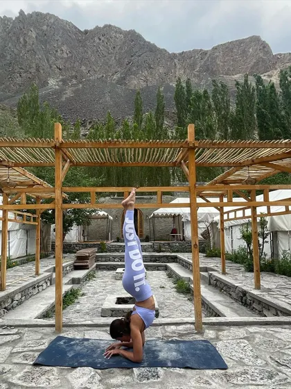 Holding a forearm stand, or Pincha Mayurasana, with the mountains of Ladakh in the background. This inversion requires significant shoulder and back strength, and I provide specific drills to build up to it.