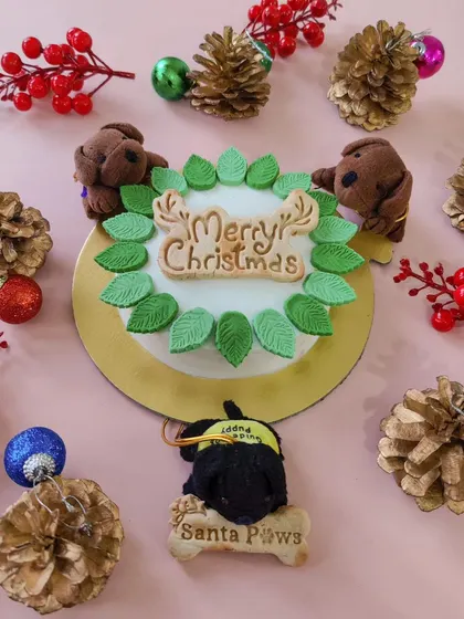 This is my 300g Christmas celebration cake, made with cranberry and blueberry. It's decorated with a 'Merry Christmas' biscuit and adorable little dog-shaped toppers.