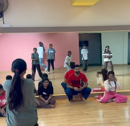 Instructors demonstrating a move while the kids watch and learn during the workshop.