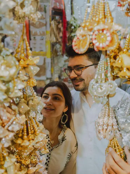 The couple explores a local market, their faces lit with curiosity and joy. These are the authentic moments that add depth to a pre-wedding film.
