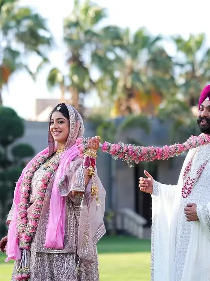 The journey of marriage begins with her playfully dragging him into the pool of forever. A fun, candid moment from a beautiful Sikh wedding.
