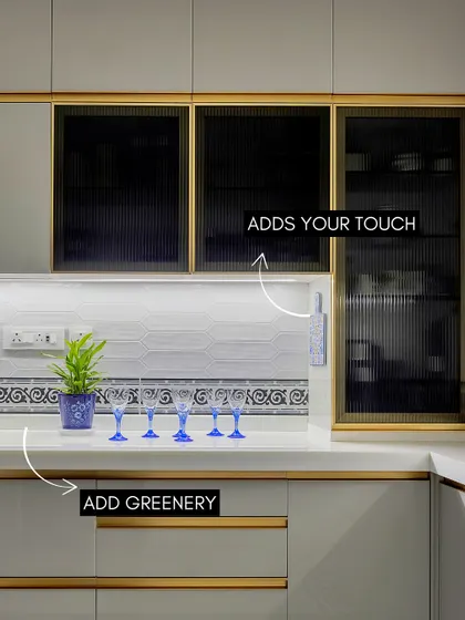 Even a functional space like a kitchen can have personality. I used fluted glass cabinets and a patterned tile border to add visual interest, while the pop of blue from the glassware brings a touch of playfulness to the clean, modern design.