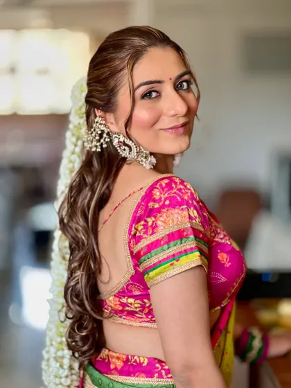 A beautiful shot from the back, showcasing the stunning waterfall gajra. This traditional floral hairstyle adds a touch of timeless elegance to any look.