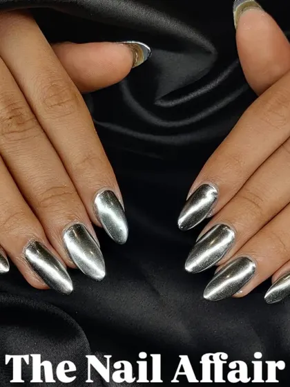 A full set of almond-shaped nails with a flawless, liquid-metal silver chrome finish. This special effect polish provides an ultra-reflective, mirror-like shine for a truly high-impact look.