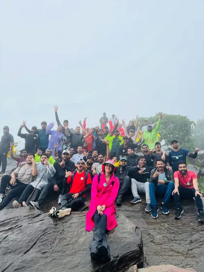Posing on the rocks at the summit. The fog adds a layer of mystery to the landscape.