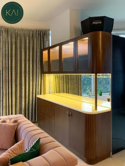 A custom-built bar and cabinet unit for a living room, featuring fluted glass doors and warm interior lighting. This piece seamlessly blends storage and display, creating a sophisticated solution for keeping things organized.