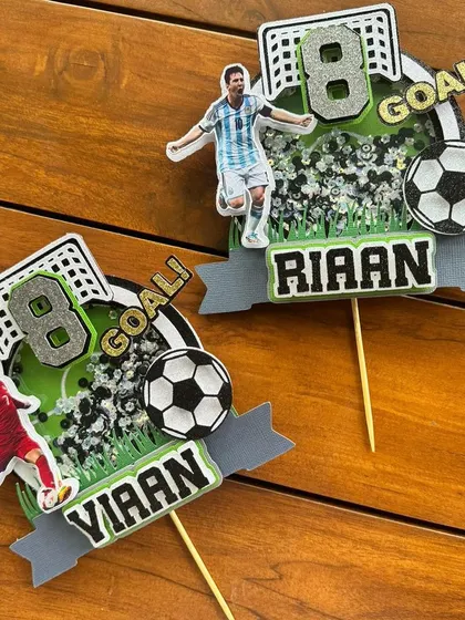 A pair of custom soccer-themed shaker toppers for a football fan's birthday. We can personalize them with different players, like Messi and Ronaldo, to match your favorite team.