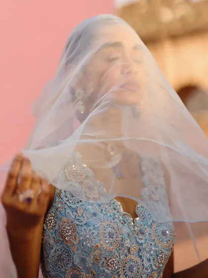 An artistic shot using a sheer veil to create a soft, mysterious mood. This type of creative direction during a shoot helps to produce evocative and memorable campaign imagery.