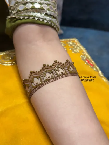 The foundational layer of the lotus arm band. The clean, crisp outlines of the lotus motifs showcase our precision and steady hand.