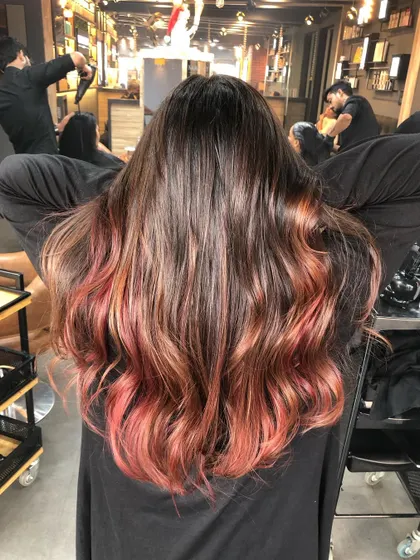 A triple-tone balayage featuring caramel, mocha, and plum. The hint of plum adds a unique and beautiful twist to the classic brown tones.