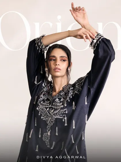 An artistic shot of the Orion Kaftan Set, capturing the movement and grace of the sumptuous silhouette and tassel details.