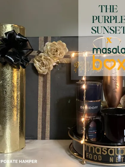 A luxurious hamper designed for Masala Box, featuring premium products like Davidoff perfume and other items arranged in an elegant gold-accented organizer.