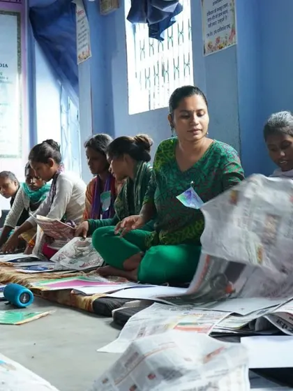 The workshop in progress. We used newspapers to cover the floor, a simple setup that allowed us to get messy and creative without worry. It shows that you don't need a fancy studio to make art, just a safe space and an open heart.