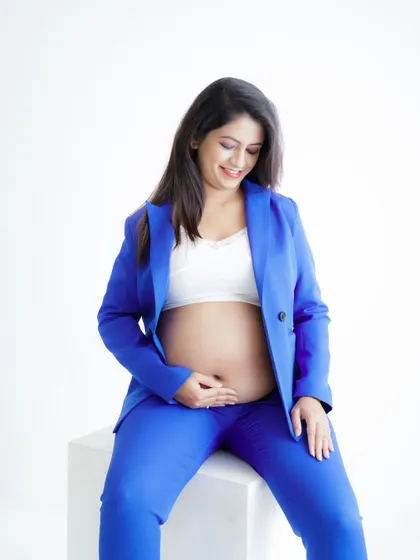 A duplicate of image 141, this chic portrait of a mom-to-be in a vibrant blue suit celebrates her strength and style.