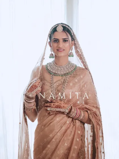 A classic, elegant portrait of the bride Namita in her beautiful pastel saree, ready for her big day.
