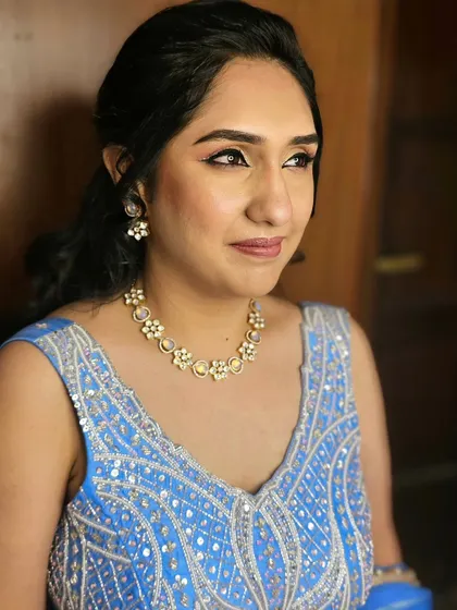 A beautiful close-up of Anishaa's engagement makeup. The clean lines of the eyeliner and the soft nude lip create a chic and modern look.