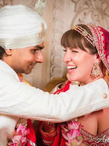 The Varmala exchange, full of laughter and joy. This shot captures the couple's happy interaction during one of the most fun wedding rituals.
