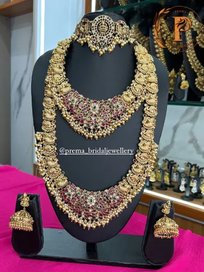 A beautiful peacock motif bridal set with red stones and pearl accents.