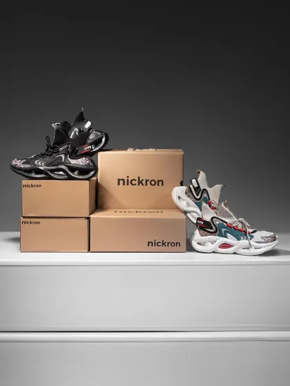 A clean studio shot displaying multiple sneaker styles with their packaging. This is a great way to showcase a new collection, giving a clear view of the different designs and color options available.