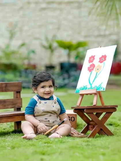 A happy little artist in our garden. The 'Lil Picasso' theme is perfect for capturing creative and joyful moments.