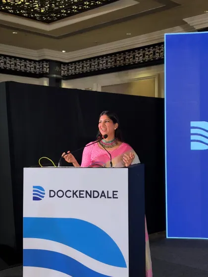 A shot from the Dockendale conference, where I am seen smiling from the podium, ready to introduce the next segment.